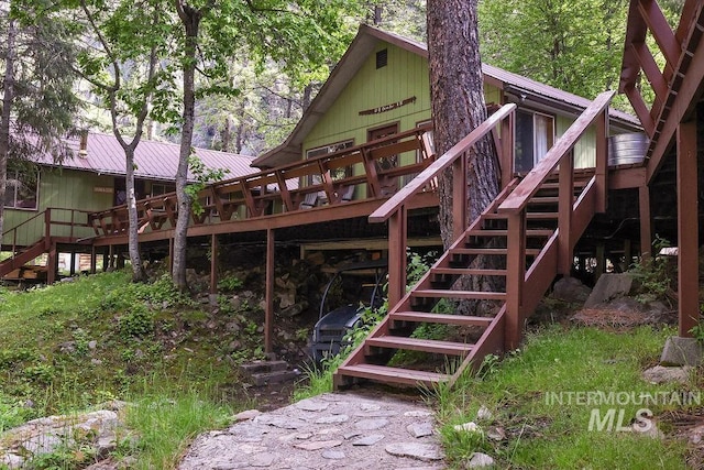 rear view of house featuring a deck