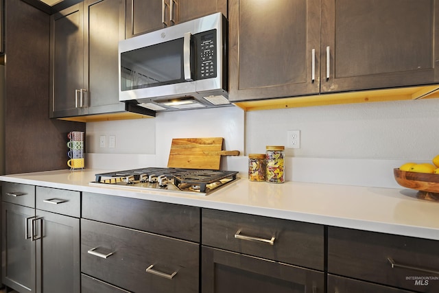 kitchen with stainless steel appliances and dark brown cabinets