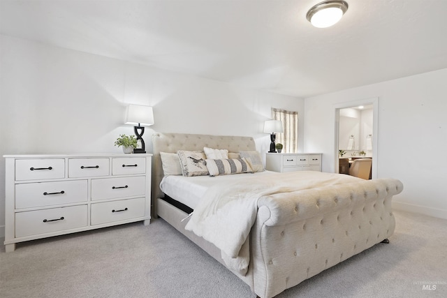 carpeted bedroom featuring ensuite bath