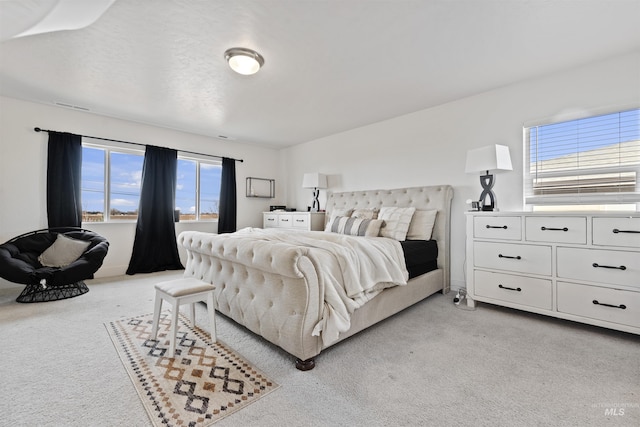 carpeted bedroom featuring multiple windows