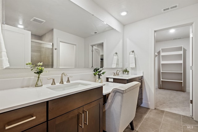 bathroom with tile patterned floors, an enclosed shower, and vanity