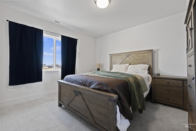 bedroom featuring light carpet