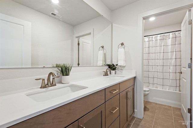 full bathroom featuring toilet, vanity, tile patterned floors, and shower / bathtub combination with curtain