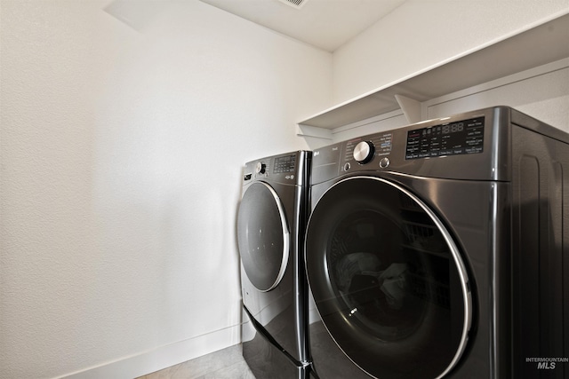 laundry room with independent washer and dryer