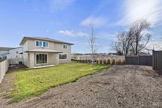 rear view of property with a yard