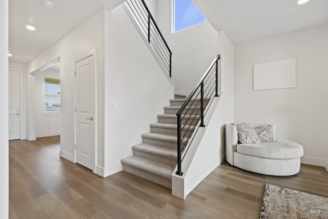 stairs featuring hardwood / wood-style flooring