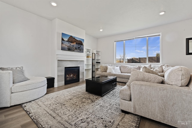 living room featuring hardwood / wood-style flooring and a tile fireplace