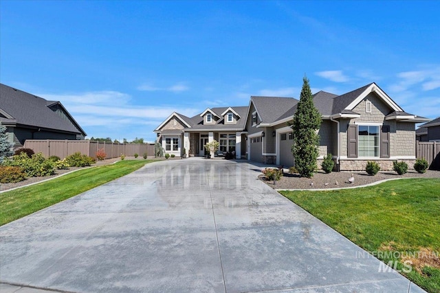 view of front of house with a garage and a front lawn