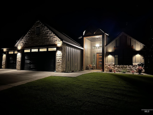 2253 Caribel St, Twin Falls, ID 83301 - view of front of house featuring stone siding, a garage, concrete driveway, a lawn, and board and batten siding