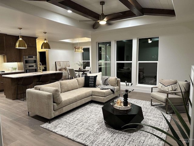 2253 Caribel St, Twin Falls, ID 83301 - living area featuring light wood-type flooring, beamed ceiling, and a ceiling fan