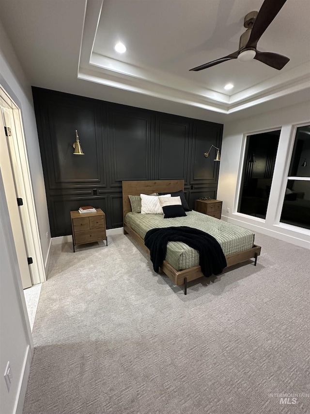 2253 Caribel St, Twin Falls, ID 83301 - bedroom with a raised ceiling, light colored carpet, recessed lighting, ceiling fan, and a decorative wall
