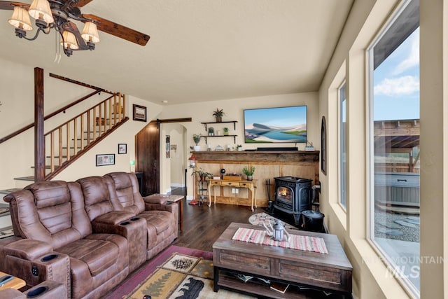 living room featuring wood-type flooring and a wood stove