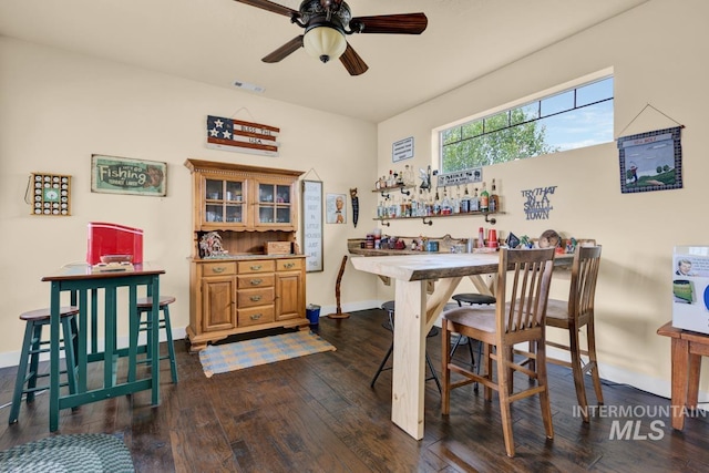 dining space with dark wood-type flooring and ceiling fan