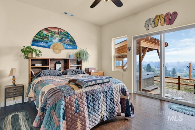 bedroom featuring dark hardwood / wood-style floors, ceiling fan, and access to exterior