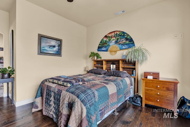 bedroom with dark hardwood / wood-style flooring