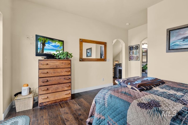 bedroom with dark hardwood / wood-style flooring