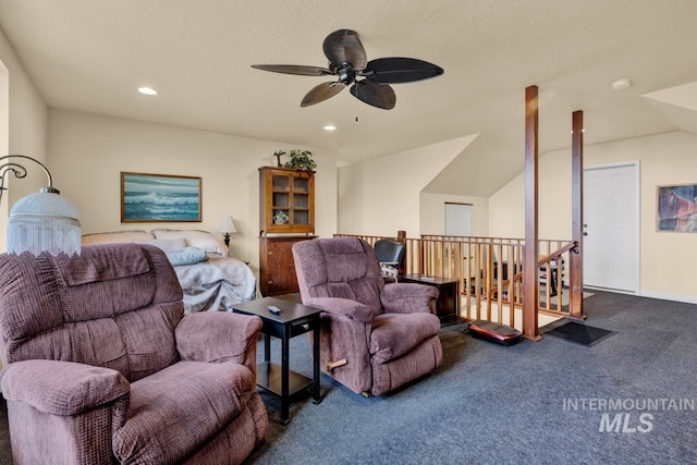 carpeted living room with lofted ceiling, ceiling fan, and a textured ceiling