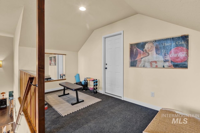 exercise room with lofted ceiling and carpet flooring