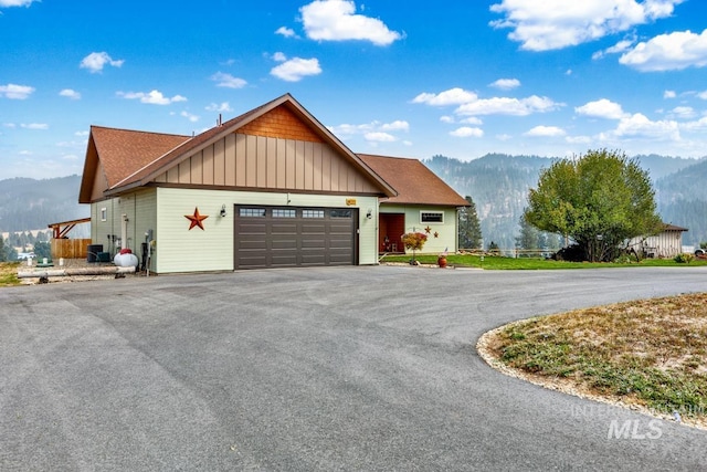 view of front facade with a mountain view and a garage