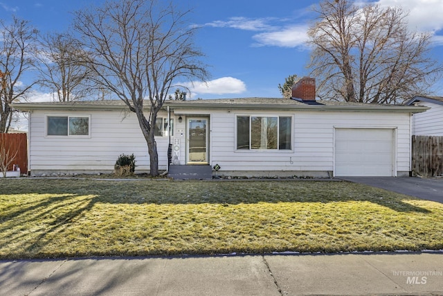 ranch-style house featuring a garage and a front yard