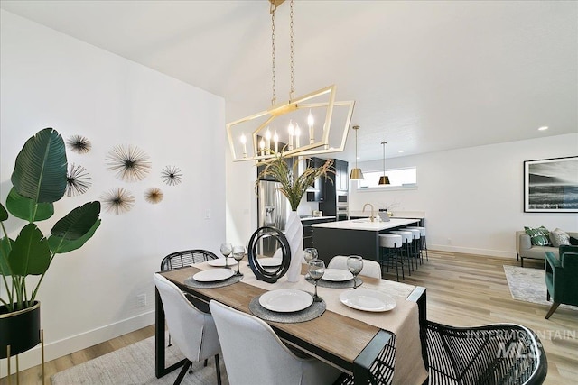 8126 N Breezy Ave, Boise, ID 83714 - dining area with a notable chandelier and light hardwood / wood-style floors
