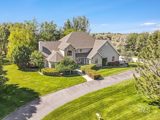 3283 Willow Cir, Twin Falls, ID 83301 - view of front of home featuring a front yard, stucco siding, and stone siding