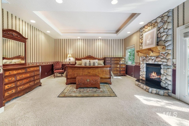 3283 Willow Cir, Twin Falls, ID 83301 - bedroom with wallpapered walls, carpet floors, a stone fireplace, a tray ceiling, and recessed lighting