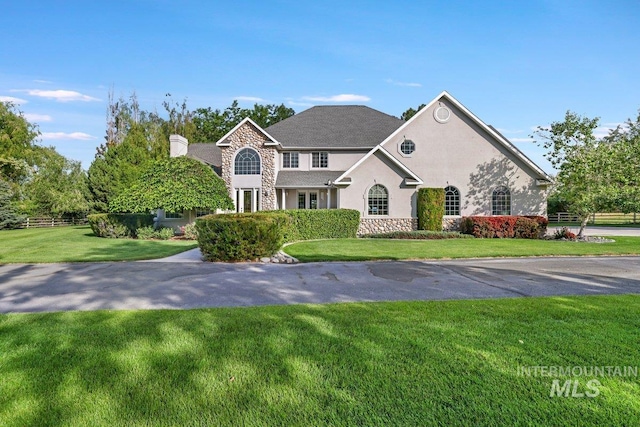 3283 Willow Cir, Twin Falls, ID 83301 - traditional home with stone siding, stucco siding, and a chimney