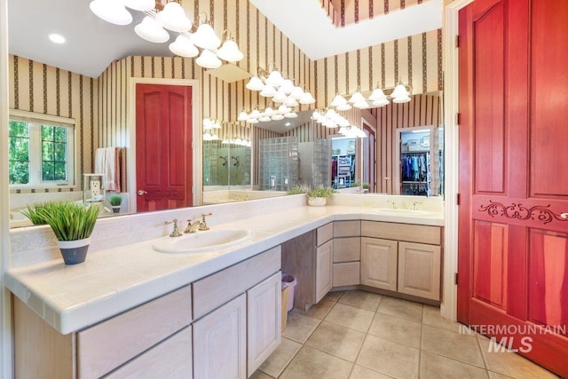3283 Willow Cir, Twin Falls, ID 83301 - bathroom featuring wallpapered walls, a chandelier, double vanity, tile patterned floors, and tiled shower
