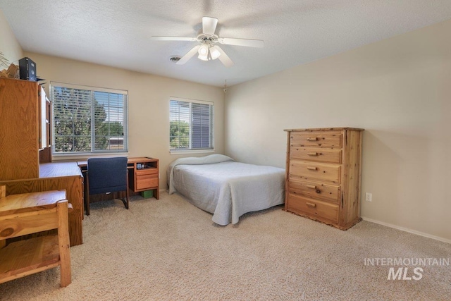 3283 Willow Cir, Twin Falls, ID 83301 - bedroom with light carpet, ceiling fan, and a textured ceiling