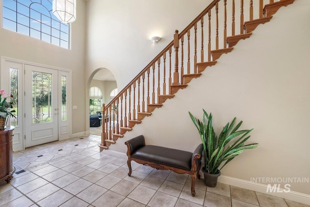 3283 Willow Cir, Twin Falls, ID 83301 - entryway with arched walkways, stairs, a high ceiling, and tile patterned flooring