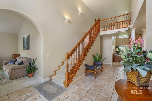 3283 Willow Cir, Twin Falls, ID 83301 - stairs with tile patterned flooring, arched walkways, and a towering ceiling