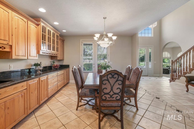3283 Willow Cir, Twin Falls, ID 83301 - dining space with arched walkways, a chandelier, recessed lighting, light tile patterned floors, and a textured ceiling