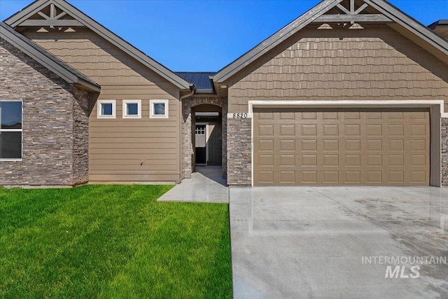 view of front of property with a garage and a front yard