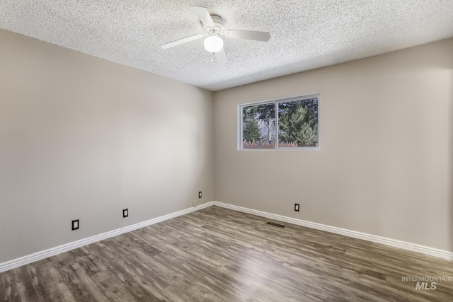spare room featuring baseboards, a textured ceiling, a ceiling fan, and wood finished floors