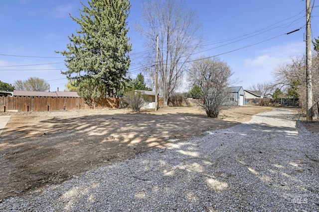view of yard with an outdoor structure and fence