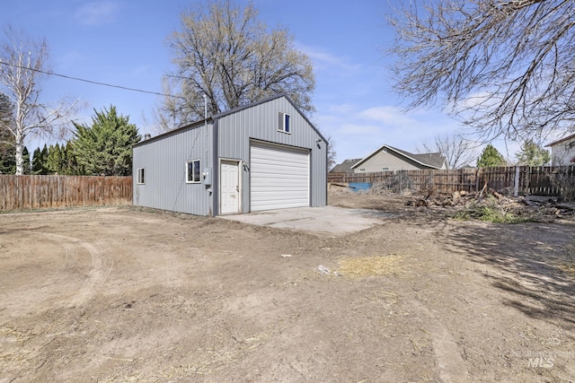 detached garage featuring fence