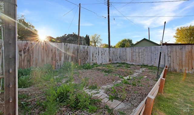 fenced backyard with a vegetable garden