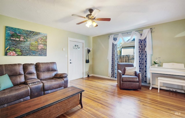 living area with ceiling fan, wood finished floors, and baseboards