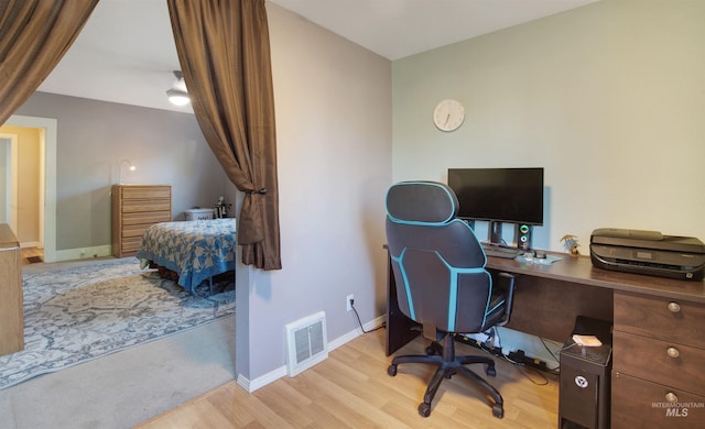 home office with wood finished floors and baseboards