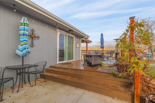 deck with a patio area and a jacuzzi