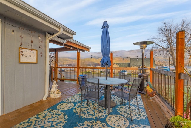 wooden deck with a mountain view