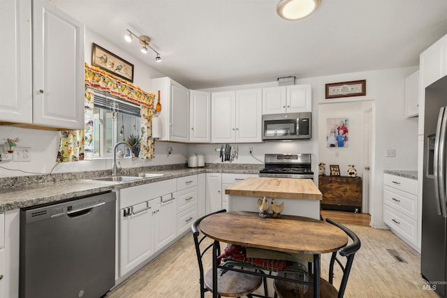 kitchen with stainless steel appliances and white cabinets