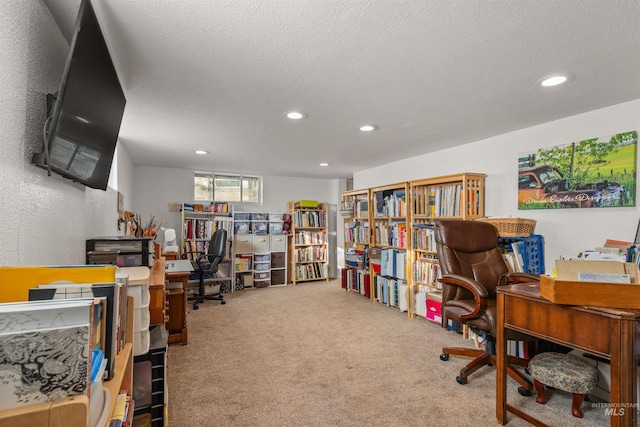 office with a textured ceiling and carpet flooring