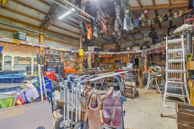 miscellaneous room with concrete flooring and a workshop area