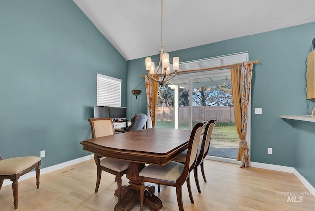 dining room with light wood-type flooring, lofted ceiling, and a notable chandelier