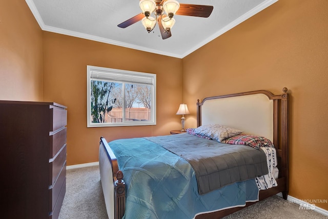 bedroom with ceiling fan, crown molding, and carpet floors