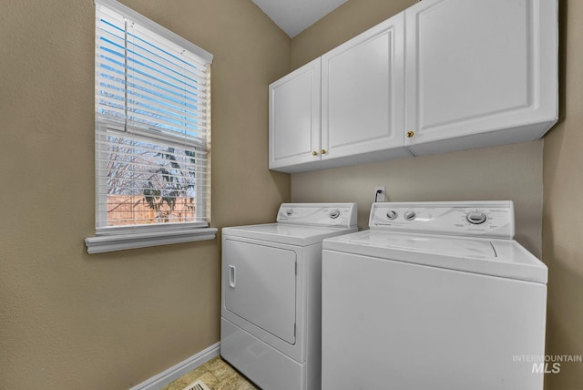 washroom featuring cabinets and independent washer and dryer