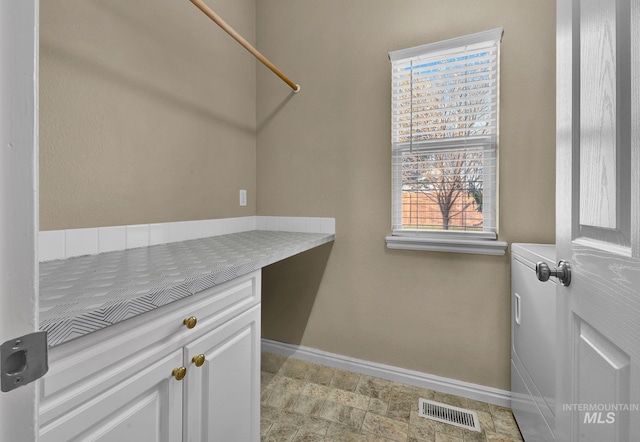 laundry area with cabinets