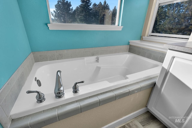 bathroom featuring tiled tub